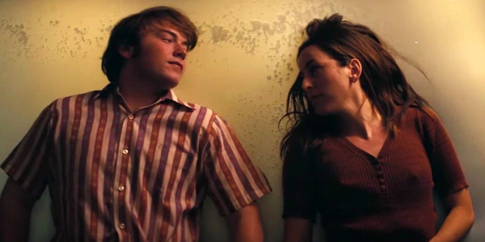Cooper Hoffman e Alana Haim, personagens do filme Licorice Pizza, numa cena onde estão deitados a olhar um para o outro.