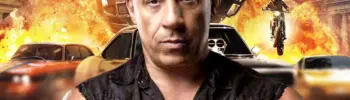 Vin Diesel em evento a promover Fast & Furious 11 com carros de corrida ao fundo